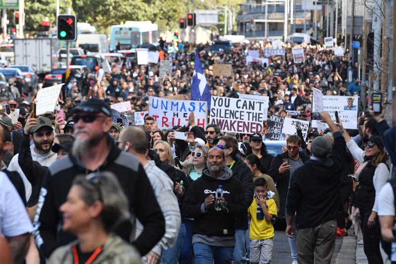 Protesters march along Broadway and George St towards Sydney Town Hall during the ‘World Wide Rally For Freedom’ anti-lockdown rally at Hyde Park in Sydney.