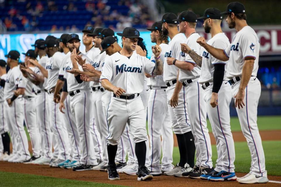 Miami Marlins manager Skip Schumaker (55) reacts with players before the first inning of an MLB game against the New York Mets at LoanDepot Park in Miami, Florida, on Thursday, March 30, 2023.