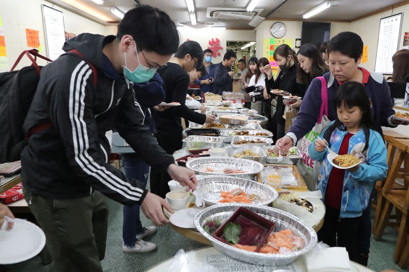 Protesters queue for a free Christmas dinner offered by a local restaurant in Hong Kong