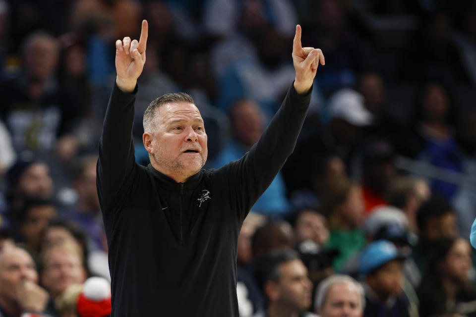 Charlotte Hornets coach Michael Malone directs the team against the Charlotte Hornets during the first half of an NBA basketball game in Charlotte, N.C., Saturday, Dec. 23, 2023. (AP Photo/Nell Redmond)