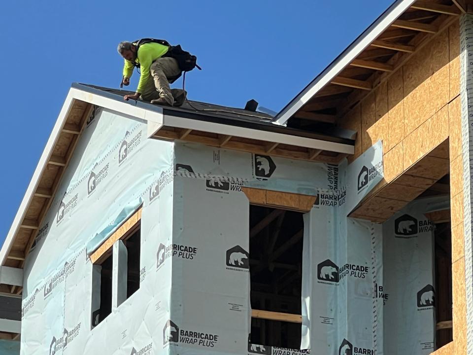 A construction worker can be seen on the roof of one of the apartment buildings going up at the Tymber Creek Village mixed-use development along LPGA Boulevard, a mile west of Interstate 95, in Daytona Beach on Wednesday, Jan. 24, 2024. The 311-unit Integra Tymber Creek luxury apartment complex is expected to welcome its first residents in the fourth quarter.