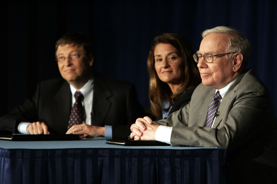 Bill Gates, left, Melinda Gates and Warren Buffett take questions during a press conference Monday, June 26, 2006, in New York.   Buffet, the chairman of Berkshire Hathaway, recently announced his intention of giving 10 million shares of his company to charitable organizations, the majority going to the Bill and Melinda Gates Foundation.  (AP Photo/Seth Wenig)