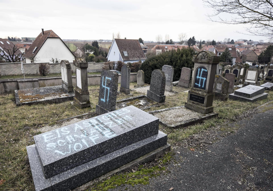 Vandalized tombs tagged with swastikas are pictured in the Jewish cemetery of Quatzenheim, in eastern France, on Feb.19, 2019. (Photo: ASSOCIATED PRESS)