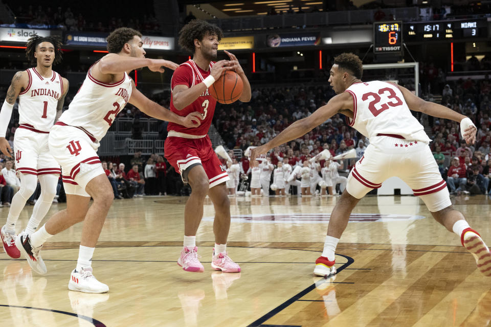 Miami (Ohio) guard Bryson Tatum (4) loses control of the ball between Indiana forwards Race Thompson (25) and Trayce Jackson-Davis (23) during the first half of an NCAA college basketball game, Sunday, Nov. 20, 2022, in Indianapolis. (AP Photo/Marc Lebryk)