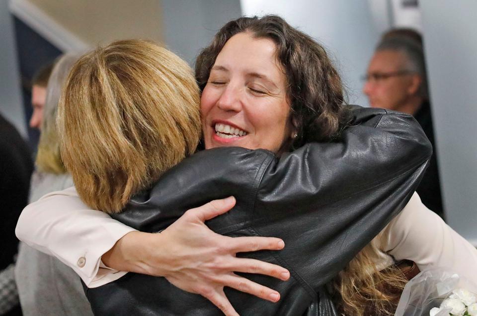 Newly elected Braintree Mayor Erin Joyce receives a hug from a resident after her swearing in at town hall Tuesday, Jan. 2, 2024.