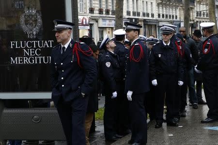 French police react after a ceremony to unveil a commemorative plaque at the site where policeman Ahmed Merabet was killed during the last year's January attack in Paris, France, January 5, 2016. REUTERS/Benoit Tessier