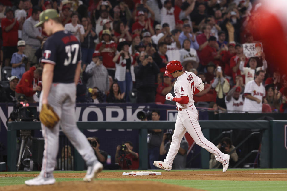 Los Angeles Angels designated hitter Shohei Ohtani (17) runs the bases after hitting a home run as Minnesota Twins starting pitcher Louie Varland (37) walks on the mound during the sixth inning of a baseball game in Anaheim, Calif., Saturday, May 20, 2023. (AP Photo/Jessie Alcheh)