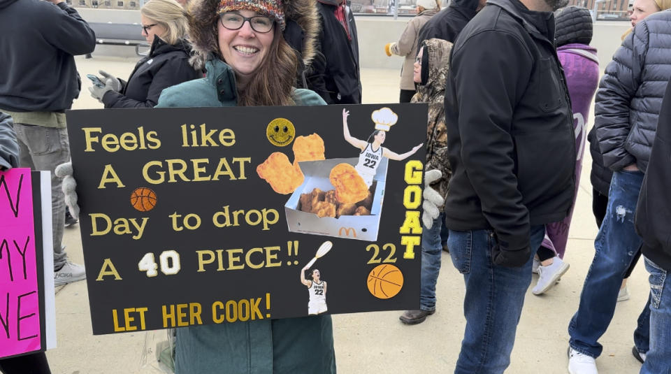 Kim Malone, of Omaha, Neb., carries a sign encouraging Iowa’s Caitlin Clark to set the NCAA college women’s basketball career scoring record when Clark's team plays Nebraska, Sunday, Feb. 11, 2024. Clark entered the game needing 39 points for the record. Malone showed up four hours before tipoff along with hundreds of other fans. (AP Photo/Eric Olson)