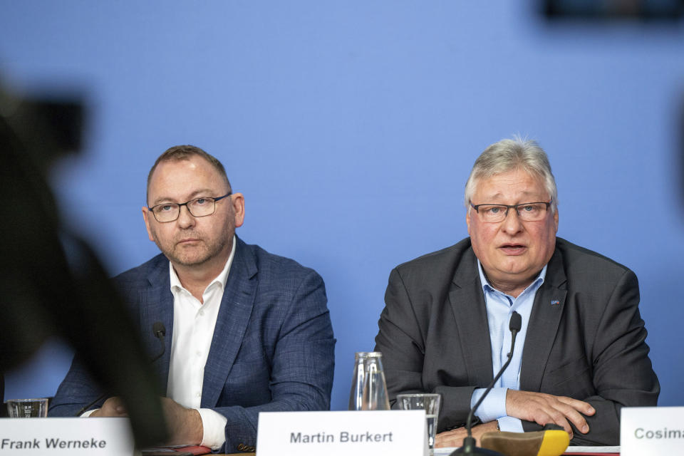 Frank Werneke, left, chairman of the Ver.di union, and Martin Burkert, chairman of the EVG union, give a joint press conference, in Berlin, Thursday, March 23, 2023. German unions are calling on thousands of workers across the country's transport system to stage a one-day strike on Monday that is expected to bring widespread disruption to planes, trains and local transit. (Monika Skolimowska/dpa via AP)