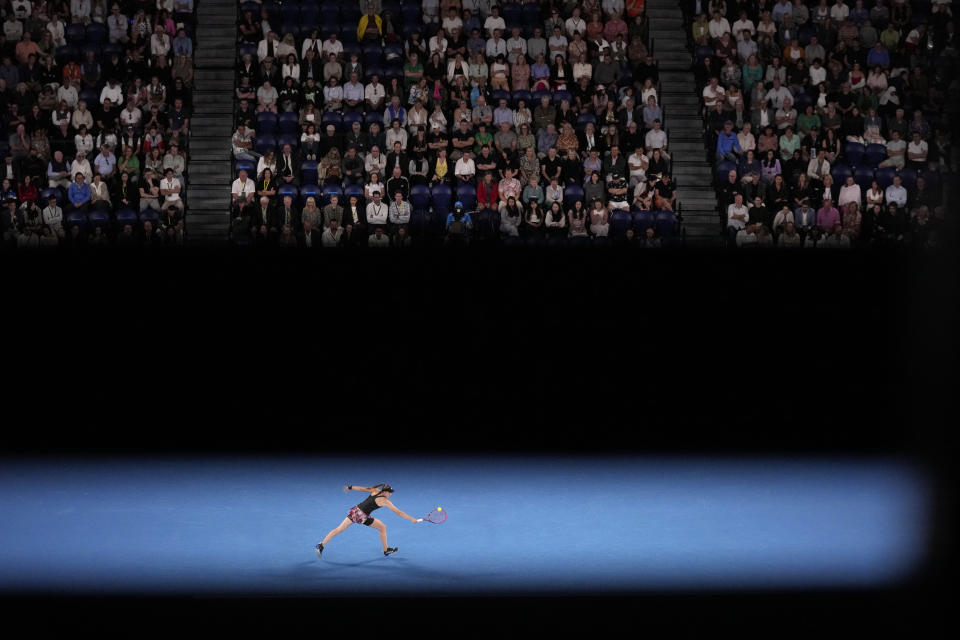 Elena Rybakina of Kazakhstan plays a backhand return to Victoria Azarenka of Belarus during their semifinal match at the Australian Open tennis championship in Melbourne, Australia, Thursday, Jan. 26, 2023. (AP Photo/Dita Alangkara)