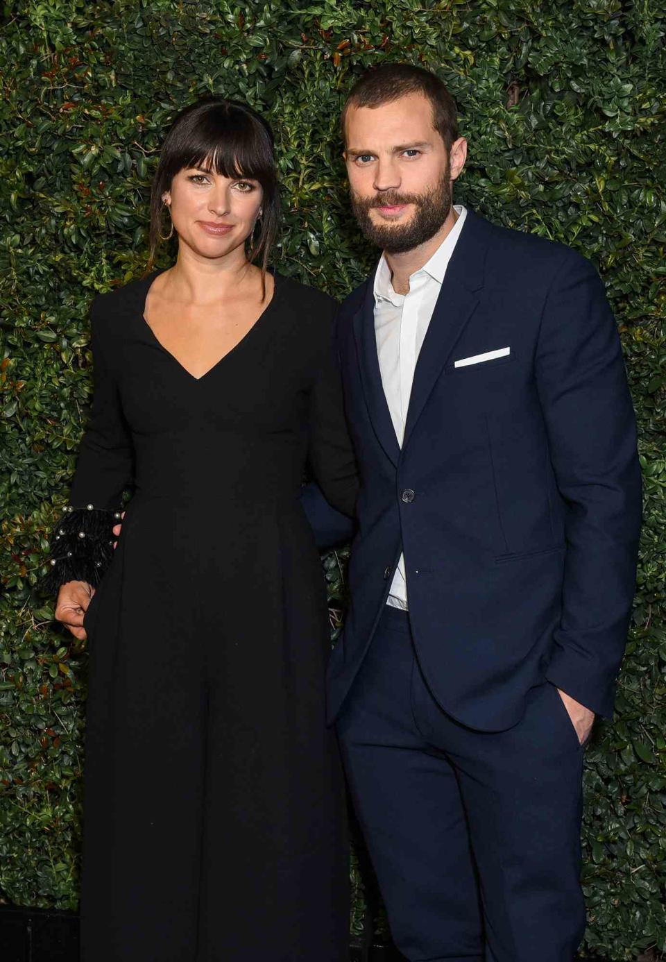 Jamie Dornan and Amelia Warner attend Charles Finch and CHANEL Pre-Oscar Awards Dinner at Madeo Restaurant on February 25, 2017 in Los Angeles, California