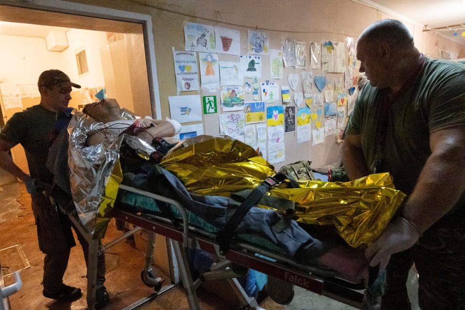 A soldier with shrapnel penetration to his chest is treated in preoperation room 2 before going on via ambulance to a hospital