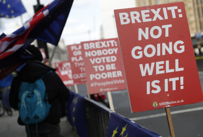 Anti Brexit and pro European Union protesters carry flags and placards as they demonstrate outside the Palace of Westminster in London, Monday, March 11, 2019. British Prime Minister Theresa May still hopes to secure changes from the EU that can win U.K. lawmakers' backing for her Brexit deal, despite a lack of progress in last-minute talks. (AP Photo/Alastair Grant)
