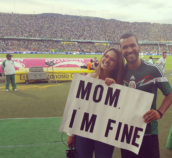 Mugging for the camera alongside TV personality Melissa Martinez at a football game in Medellin. 