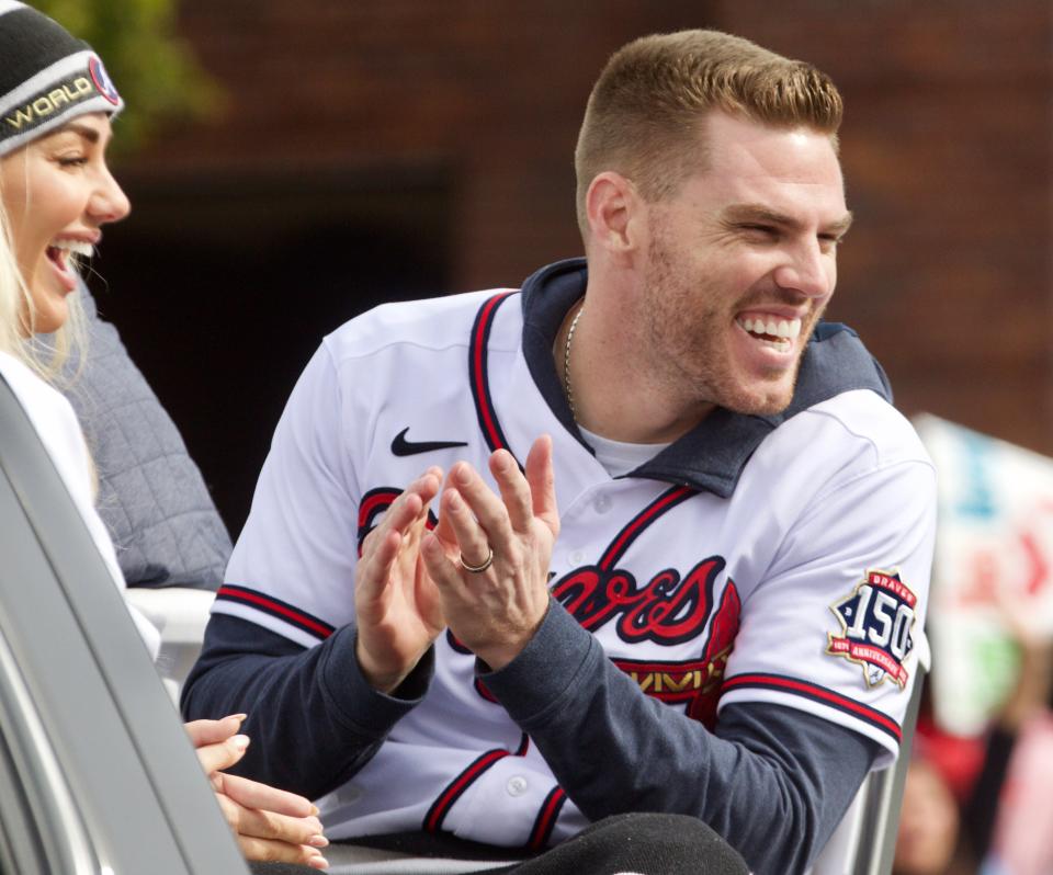 Atlanta Braves' Freddie Freeman talks to the crowd as the team's 2021 World Series baseball champion victory parade heads down Cobb Parkway toward Truist Field in Atlanta, Friday, Nov. 5, 2021. (Steve Schaefer/Atlanta Journal-Constitution via AP)