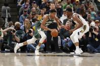 Dec 12, 2018; Indianapolis, IN, USA; Milwaukee Bucks forward Giannis Antetokounmpo (34) is guarded by Indiana Pacers forward Thaddeus Young (21) during the third quarter at Bankers Life Fieldhouse. Mandatory Credit: Brian Spurlock-USA TODAY Sports