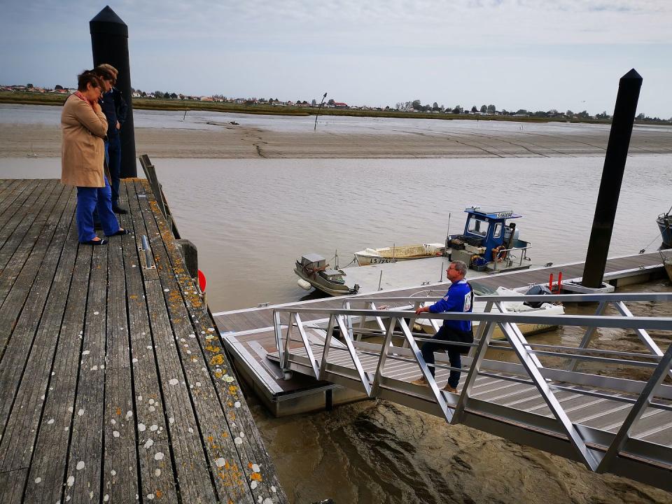 Anne and Jean Birault talk to a fisherman at La Faute-sur-Mer.