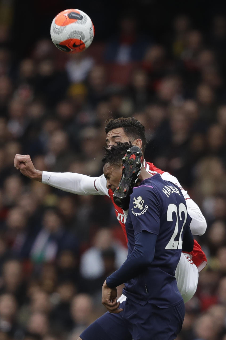 Arsenal's Pablo Mari, back, jumps for the ball with West Ham's Sebastien Haller during the Premier League soccer match between Arsenal and West Ham at the Emirates Stadium in London, Saturday, March 7, 2020.(AP Photo/Matt Dunham)