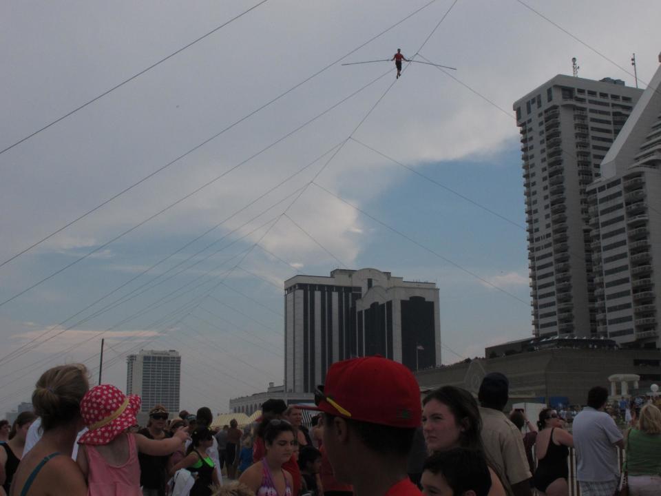 A crowd watches as daredevil Nik Wallenda walks a tightrope above the beach at Atlantic City on Thursday, Aug. 9, 2012. Officials say some 150,000 people witnessed the walk. (AP Photo/Geoff Mulvihill)