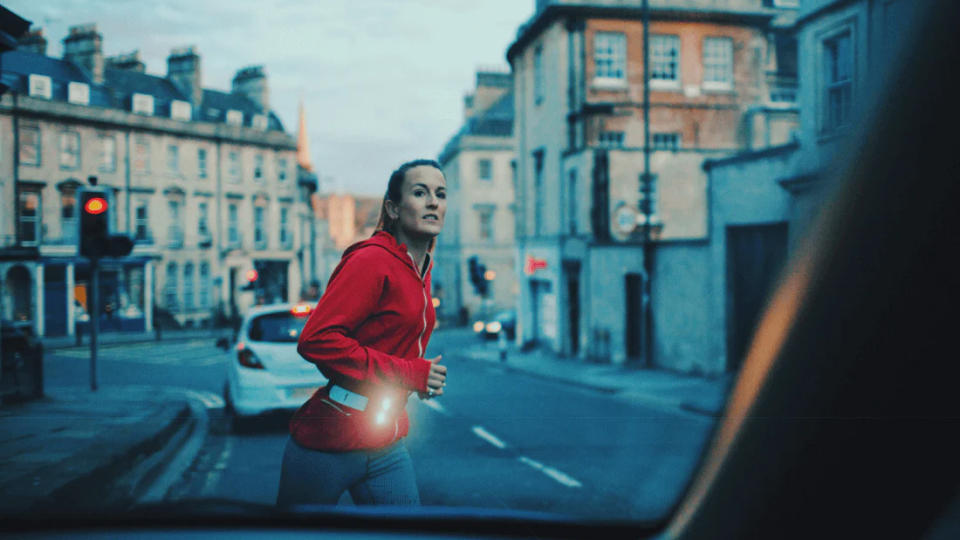 Woman running at dusk wearing Million Mile Light