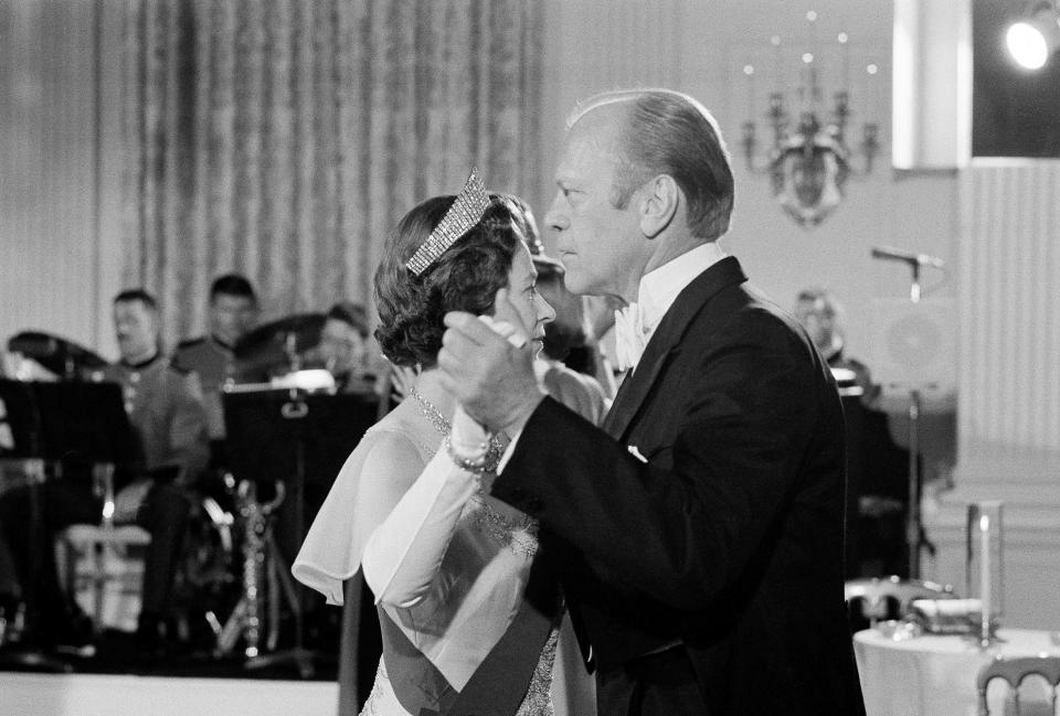 FILE - In this file photo dated July 7, 1976, U.S. President Gerald Ford dances with Britain's Queen Elizabeth II in the State Dining Room at the White House, following a State Dinner in the queen's honor. (AP Photo/John Duricka, File)