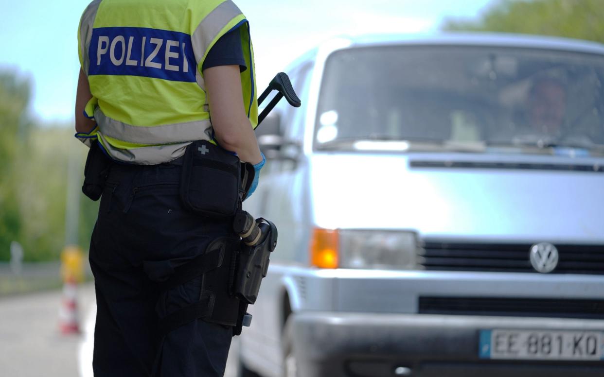 RASTATT, GERMANY - MAY 08: A German border police officer stops cars in a checkpoint of the D87 road at the German-French border during the coronavirus crisis on May 8, 2020 near Rastatt, Germany. The rates of new infections in both Germany and France, as in much of the European Union, have fallen dramatically over recent weeks, allowing governments to ease lockdown measures and strengthening demands by both business leaders and local communities to reopen international borders. In Germany so far Interior Minister Horst Seehofer is resisting a fast-paced lifting of border closures. (Photo by Thomas Niedermueller/Getty Images) - Thomas Niedermueller/ Getty Images Europe