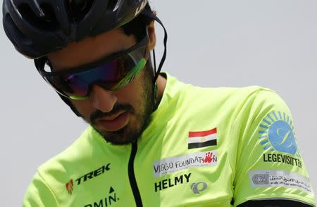 Egyptian cyclist Helmy El Saeed, 27, looks at his bicycle and training on the highway of El Ain El Sokhna, east of Cairo, Egypt July 19, 2017. REUTERS/Amr Abdallah Dalsh