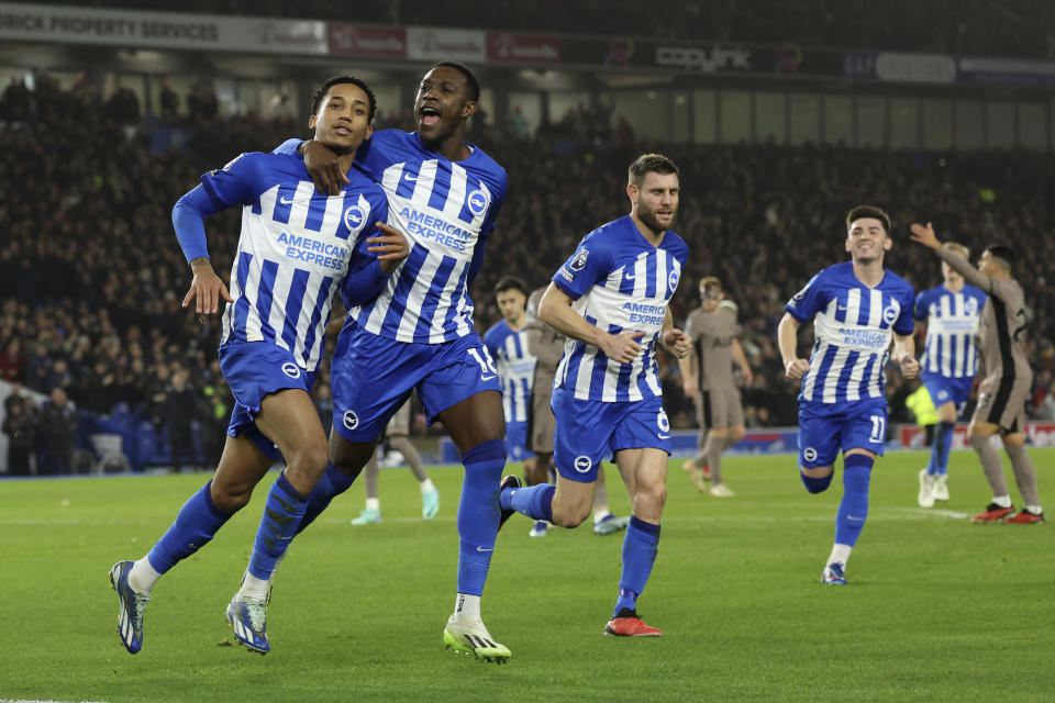 Brighton's Joao Pedro, right, celebrates with Danny Welbeck, left, after scoring his side's second goal from the penalty spot during the English Premier League soccer match between Brighton & Hove Albion and Tottenham Hotspur at the Amex stadium in Brighton, England, Thursday, Dec. 28, 2023. (AP Photo/Ian Walton)