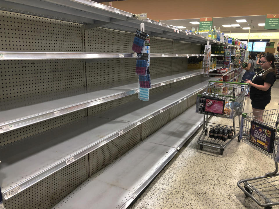 Store shelves are empty of bottled water as residents buy supplies in preparation for Hurricane Dorian, in Doral, Fla., Thursday, July 29, 2019. The U.S. National Hurricane Center says Dorian could hit the Florida coast over the weekend as a major hurricane. (AP Photo/Marcus Lim)
