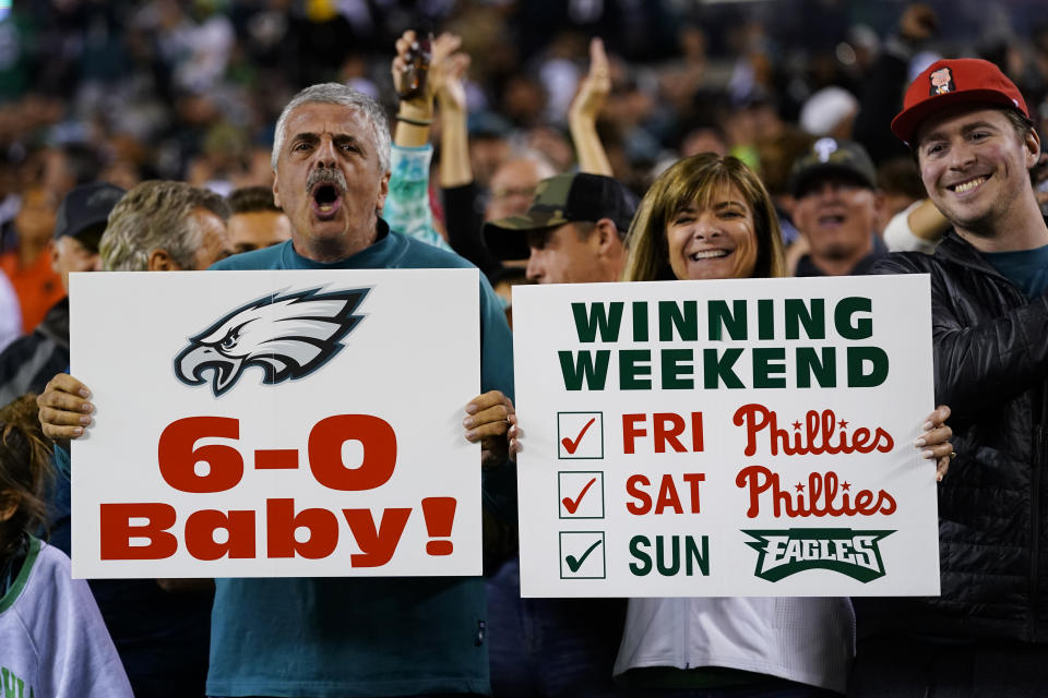 Philadelphia Eagles fans display signs for the undefeated Eagles and the Philadelphia Phillies after an NFL football game against the Dallas Cowboys on Sunday, Oct. 16, 2022, in Philadelphia. (AP Photo/Chris Szagola)