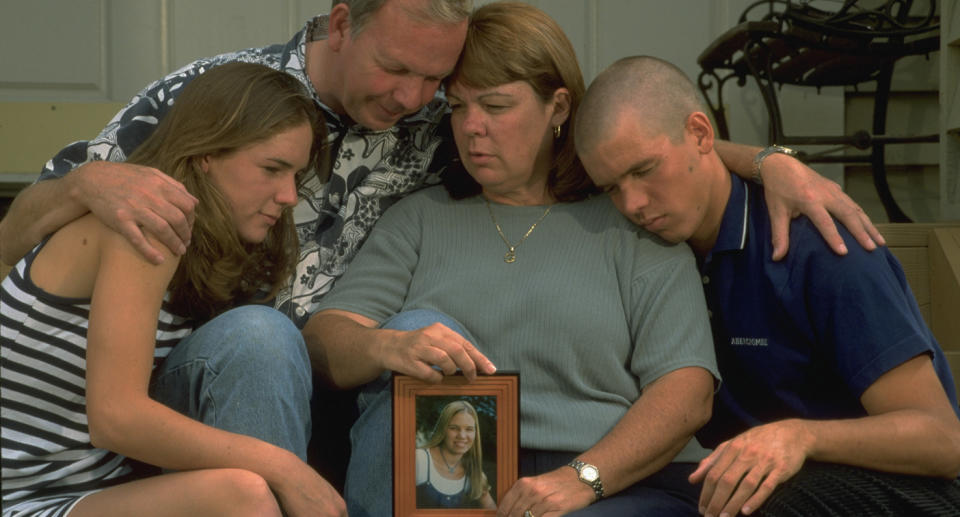 The Smart family (pictured) with a photo of missing woman Kristin Smart.