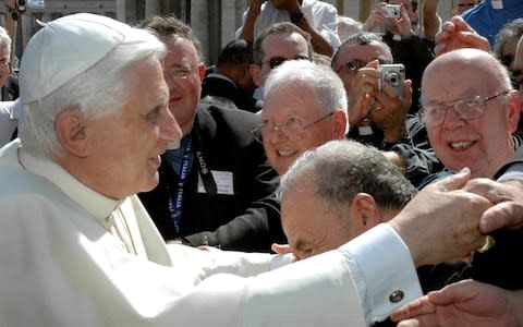 Pope Benedict XVI with worshippers - Credit: Olycom SPA/REX/Shutterstock