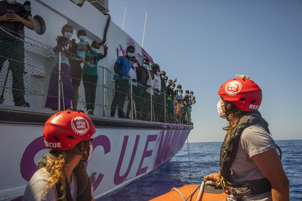 Members of the Astral crew, a rescue ship from the Spanish NGO Open Arms, approach the Louise Michel rescue vessel, a French patrol boat currently manned by activists and funded by the renowned artist Banksy in the Central Mediterranean sea, at 50 miles south from Lampedusa, Friday, Aug. 28, 2020. A Berlin-based group says it has begun migrant rescue operations in the Mediterranean Sea with a bright pink former navy vessel sponsored by British artist Banksy. The group operating the MV Louise Michel, a sleek 30-meter (98-foot) ship named after a 19th century French feminist and anarchist, said late Thursday that it rescued 89 from an inflatable boat in distress. (AP Photo/Santi Palacios)