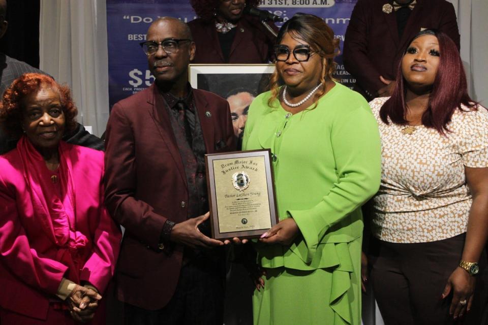Pastor LaShon Young, pastor of Fresh Start Ministries, center right, was awarded the 2023 Drum Major for Justice Faith Leader Award by Rodney Long, center left. Ariana Young, LaShon Young's daughter, far right, and Jackie Hart, far left, are also pictured.
(Photo: Photo by Voleer Thomas/For The Guardian)