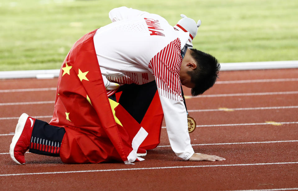 China's Su Bingtian rests on the track after winning the gold medal in the men's 100m final during the athletics competition at the 18th Asian Games in Jakarta, Indonesia, Sunday, Aug. 26, 2018. (AP Photo/Bernat Armangue)