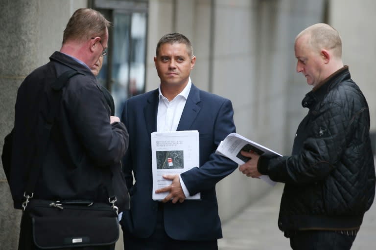 Former British actor John Alford (centre) waits outside the Old Bailey in London, on October 21, 2016. Alford -- who was caught in a sting by British journalist Mazher Mahmood, has accused the so-called 'Fake Sheikh' of being "a serial perjurer"