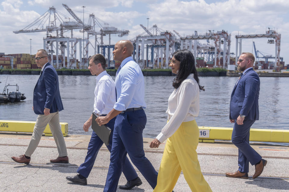 Transportation Secretary Pete Buttigieg, second from left, Maryland's Governor Wes Moore, center, and Lieutenant Governor Aruna Miller, second from right, arrive for a press conference to mark the full reopening of the Port of Baltimore after the collapse of the Francis Scott Key Bridge in March, Wednesday, June 12, 2024, at the Port of Baltimore in Dundalk, Md. (AP Photo/Mark Schiefelbein)
