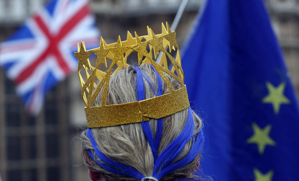 A pro EU protestor demonstrates opposite The Houses of Parliament in London, Tuesday, April 2, 2019. British Prime Minister Theresa May is set for a marathon session with her Cabinet as the government tries to find a way out of the Brexit crisis, after lawmakers again rejected all alternatives to her European Union withdrawal agreement. (AP Photo/Frank Augstein)