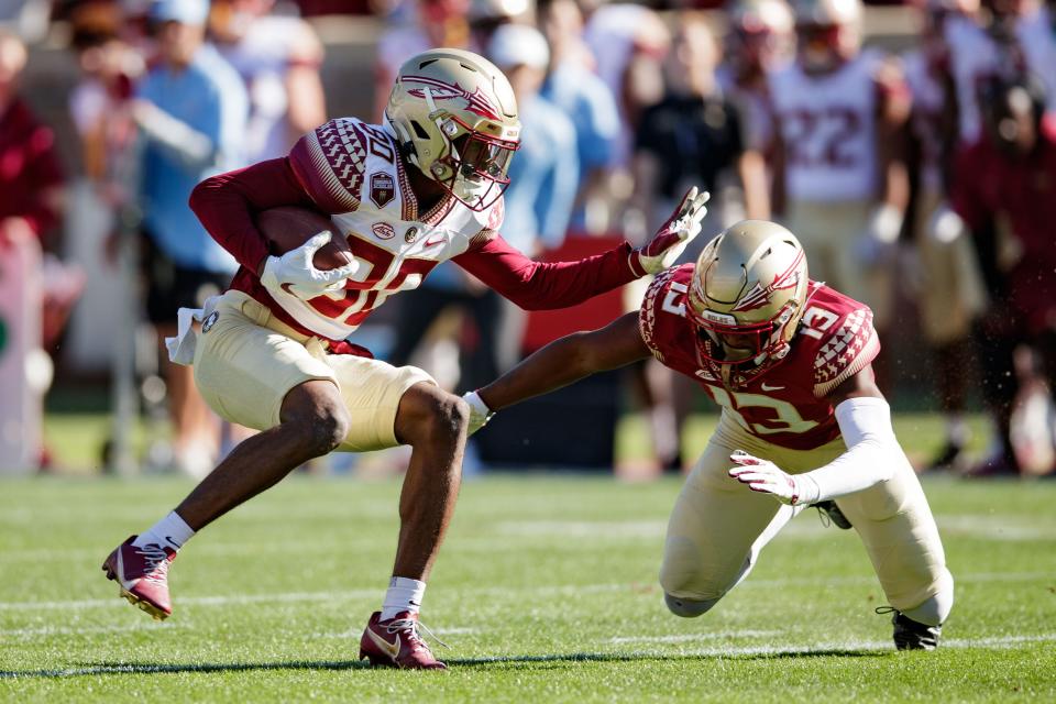 Florida State Seminoles wide receiver Ontaria Wilson (80) fights off a tackle from Florida State Seminoles defensive back Omarion Cooper (13). The Florida State Seminoles hosted their annual Garnet and Gold spring game at Doak Campbell Stadium on Saturday, April 9, 2022.
