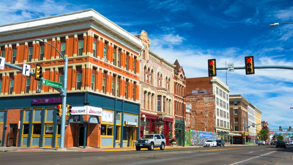 Cheyenne, United States - September 22, 2015: Downtown Cheyenne street scene with historic buildings and car with driver in an intersection.