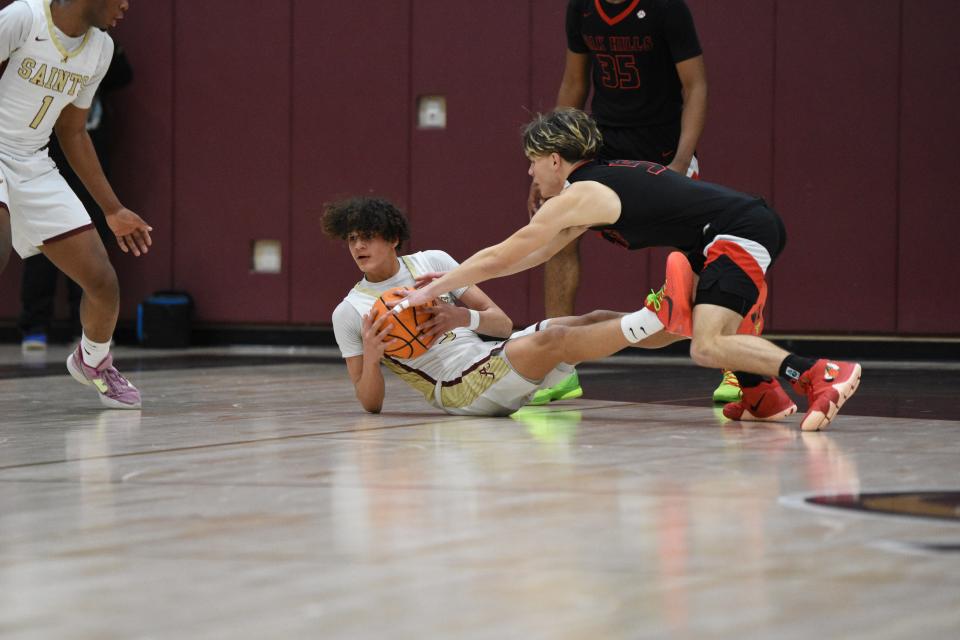 Adelanto’s Kimo Brown Jr. and Oak Hills Hunter Wilcox battle for the ball during the first quarter on Saturday, Jan. 20, 2024. Oak Hills beat Adelanto 63-57 in the showcase featuring two of the top programs in the High Desert.