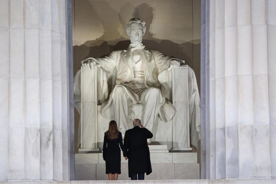 President-elect Donald Trump, right, salutes as he arrives with his wife Melania Trump to the "Make America Great Again Welcome Concert" at the Lincoln Memorial, Thursday, Jan. 19, 2017, in Washington. (AP Photo/Evan Vucci)