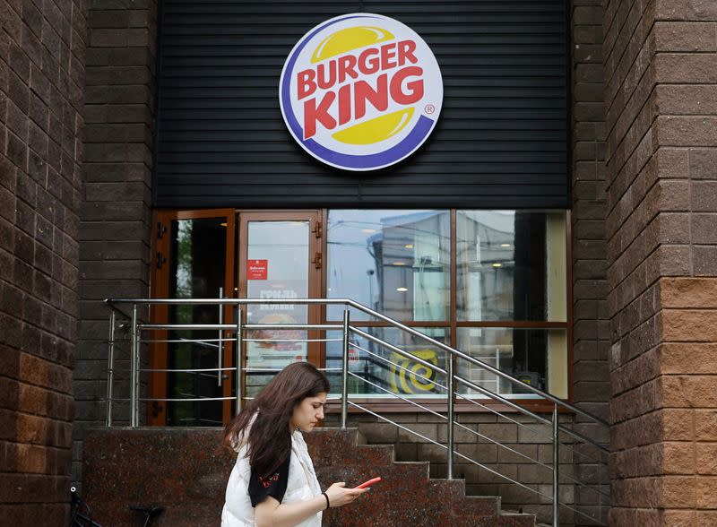 A woman walks past a Burger King restaurant in Moscow