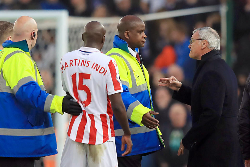 Security staff stand in-between Stoke City's Bruno Martins Indi, second left, and Leicester City manager Claudio Ranieri, right, during their English Premier League soccer match at the Bet365 Stadium, Stoke, England, Saturday, Dec. 17, 2016. (Mike Egerton/PA via AP)