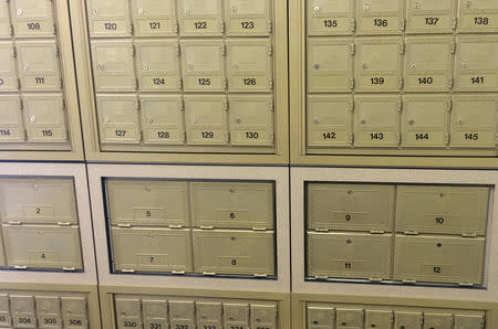 Banks of Mail Boxes Etc.Õs signature golden mail boxes are seen at a branch at 43 Bedford Street in London, Britain, August 25, 2016. REUTERS/Tom Bergin