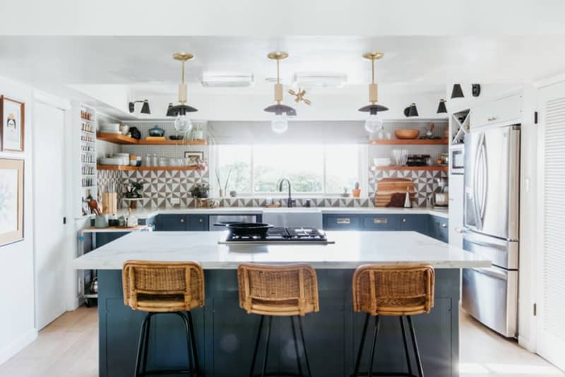 White kitchen with blue island and cabinets