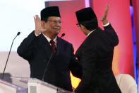 Indonesian presidential candidate Prabowo Subianto reacts with running mate Sandiaga Uno, right, after a televised debate in Jakarta, Indonesia, Thursday, Jan. 17, 2019. Indonesia is gearing up to hold its presidential election on April 17 that will pit in the incumbent against the former general.(AP Photo /Tatan Syuflana)