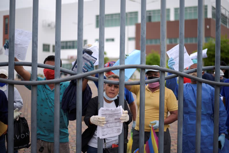 People protest against the difficulty of recovering the bodies of relatives at Guasmo Sur General Hospital after Ecuador reported new cases of coronavirus disease (COVID-19), in Guayaquil