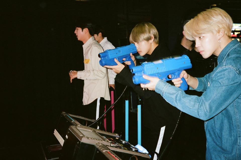 V and Jimin try a shooting game, while Jungkook and Jin do DDR.