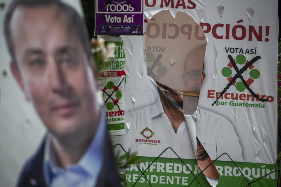 In this Thursday, June 13, 2019, photo, a vandalized campaign poster of Manfredo Marroquin, presidential candidate of the Encuentro political party, is displayed in Guatemala City. The road to Sunday’s vote has been a flurry of court rulings and shenanigans, illegal party-switching and allegations of malfeasance that torpedoed some candidacies. (AP Photo/Moises Castillo)